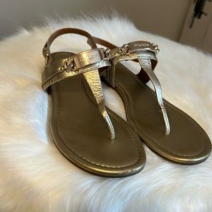 Coach gold flat sandals.